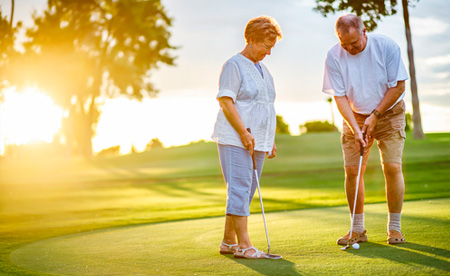 An Elderly Couple Playing Golf