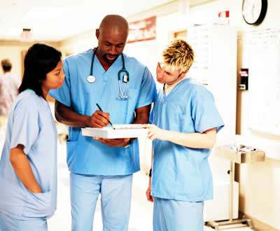 Three Medical Helpers Talking to Each Other