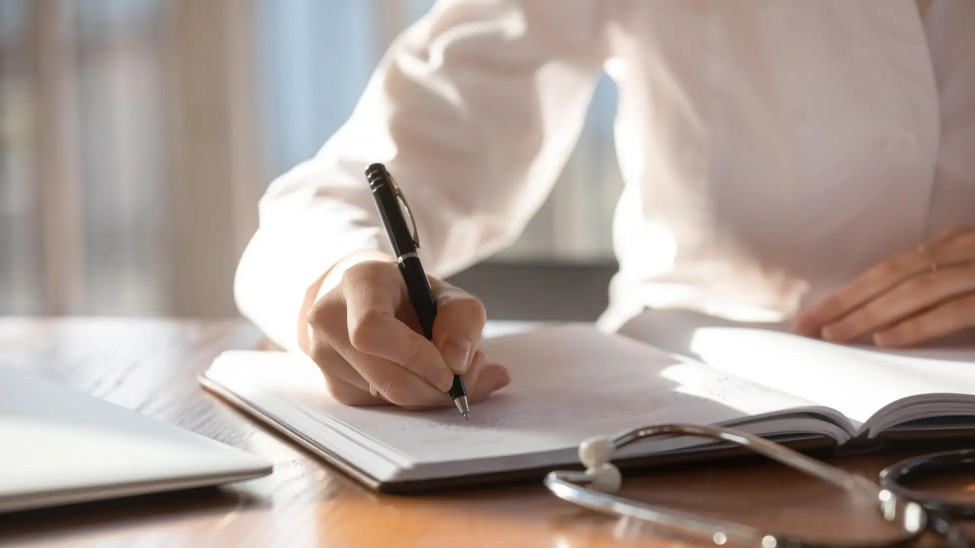 A man writing a note on a notebook