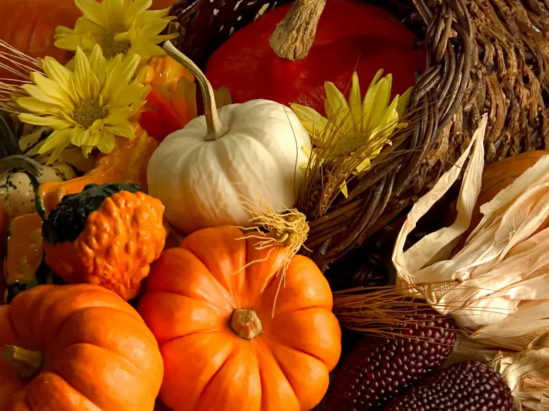 A basket of plastic pumpkins and flowers