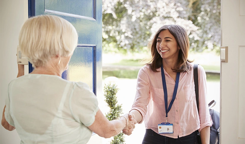 New client and caregiver shake hands as they meet for the first time