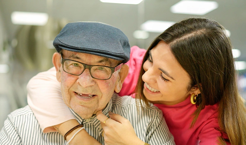 An elderly man and a woman share a joyful moment together.