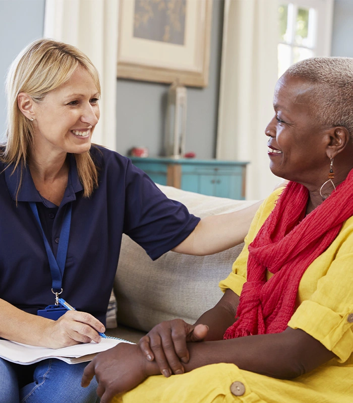 Care coordinator meeting with senior woman