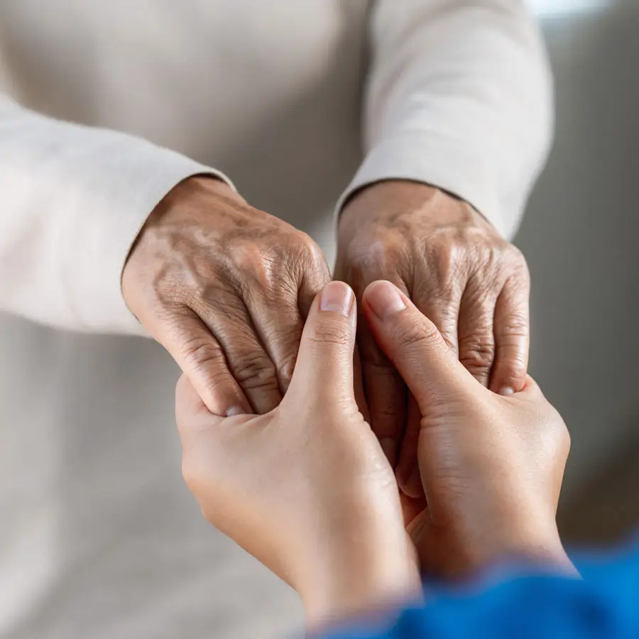 Two people holding hands