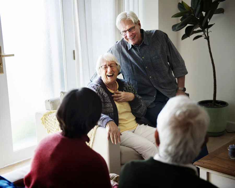 Senior couple with friends visiting